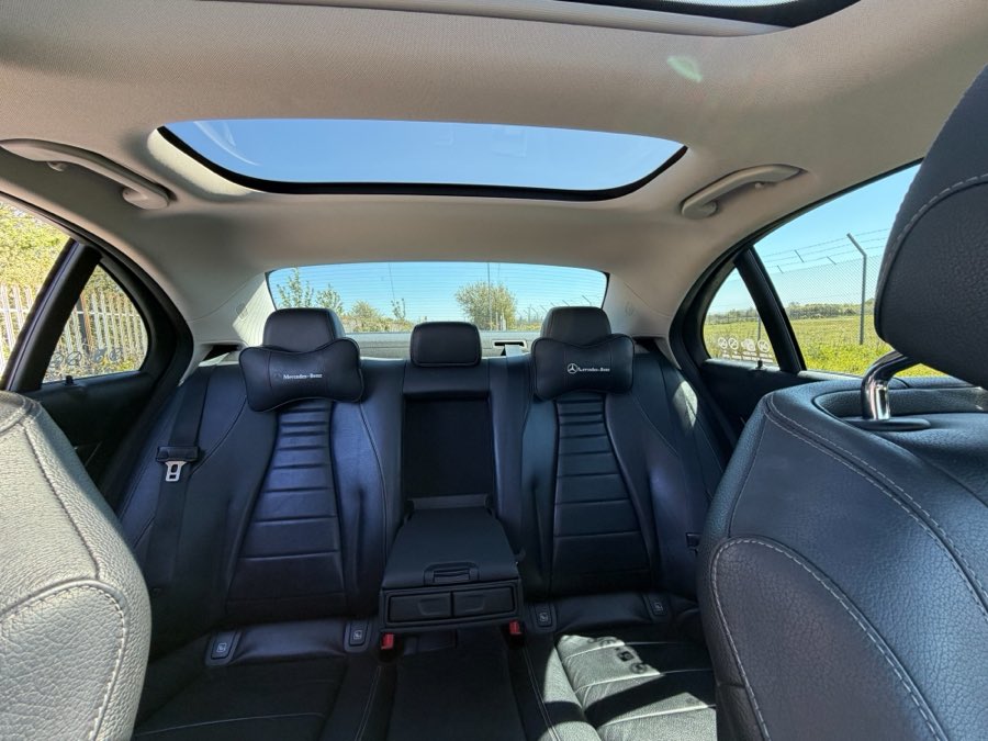 Inside the Mercedes E-Class, looking up through the panoramic sunroof